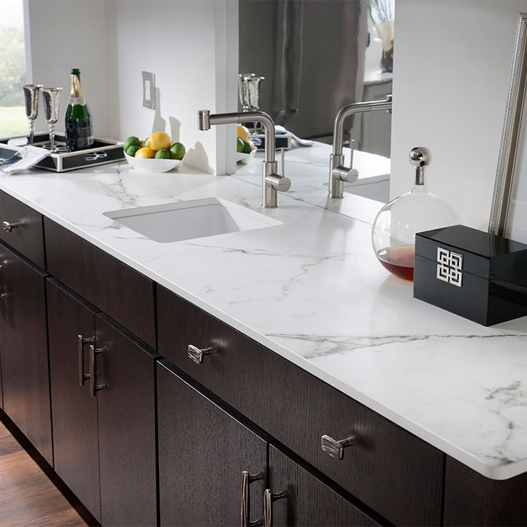 Dekton Kairos white marble effect Stone bathroom worktops paired with dark wood cabinets