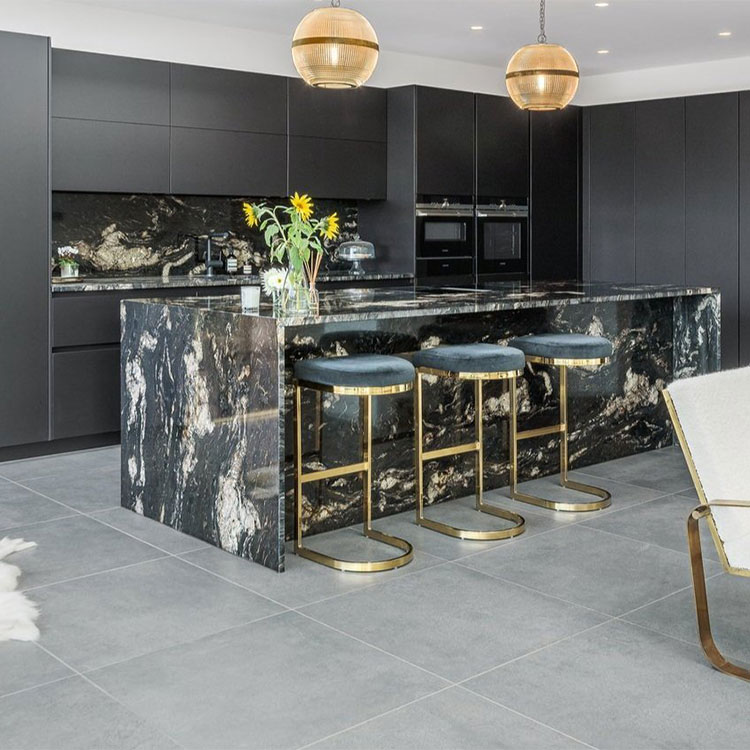 Large black granite kitchen island with white veining and waterfall edge detailing installed at home in West Sussex by Design Interiors and LBS Stone collection