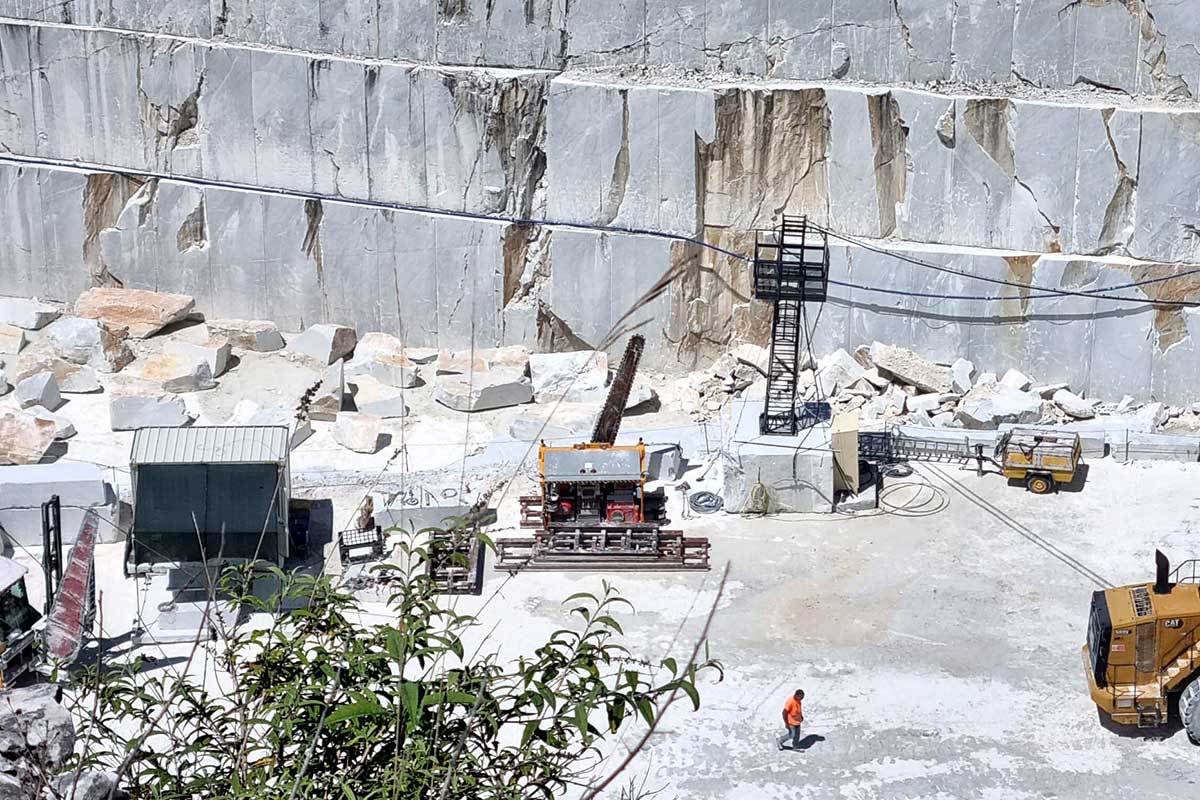 A newly cut and extracted 20 tonne block of Carrara marble sitting at the base of the rock face in the quarry at Canalgrande Alto in Italy