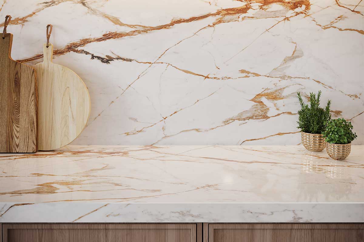 Beautiful sintered stone kitchen worktop and splashback featuring Dekton white marblke effect Onirika AWake marble effect stone with rich rust coloured veins