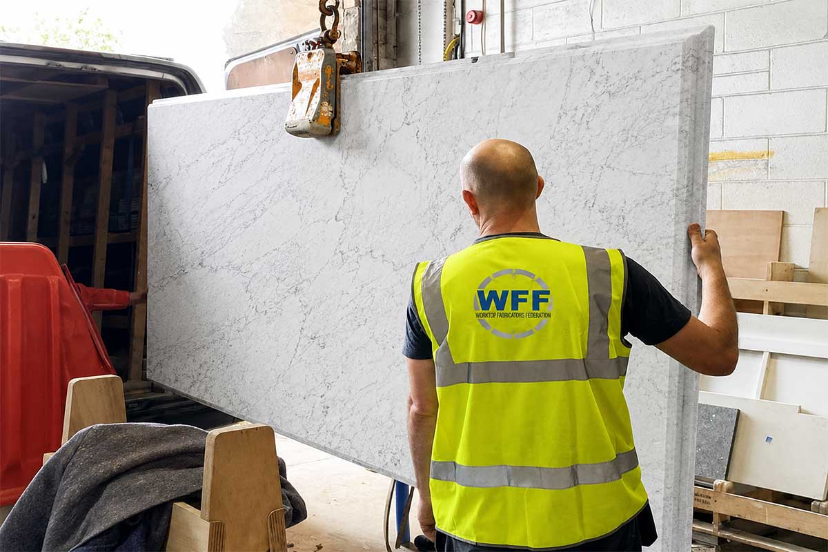 Large carrara marble kitchen island worktop being craned into a lorry ready for delivery and installation in West Sussex by LBS Stone