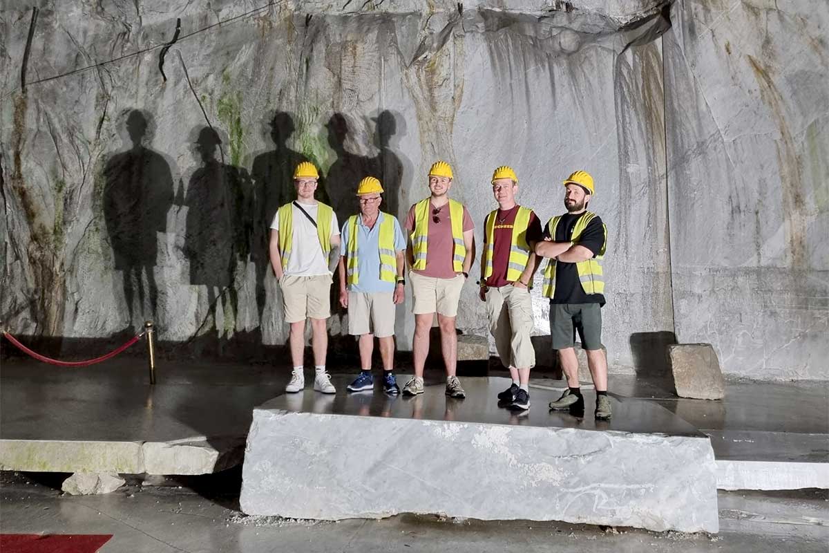 Members of the LBS Stone picture in one of the underground caverns at the Carrara Marble Quarry No. 83 Canalgrande Alto in the Tuscan Alps of Italy